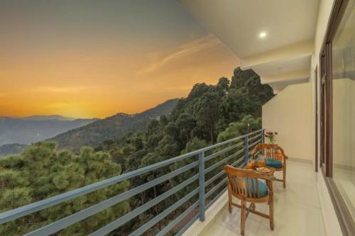 a balcony with a view of a mountain at Wonder Inn Kasauli in Kasauli