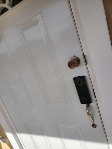 a white door with a lock on it at The Surada Bay in Old Harbour