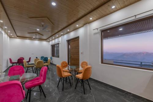 a room with chairs and a table and a window at Wonder Inn Kasauli in Kasauli