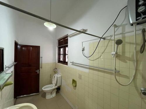 a bathroom with a shower and a toilet and a sink at Bellevue Retreat in Kandy