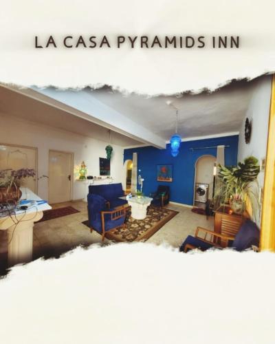 a living room with blue walls and a blue couch at La Casa pyramids Inn in Cairo