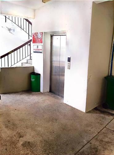 an empty room with a door and a staircase at Bidadari Lagoon 4 Islamic Homestay in Port Dickson