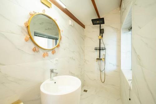 a bathroom with a sink and a mirror at Shanghai Hills & Serendipity Roof House in Shanghai