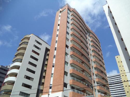 a tall building with a large window at Brisa do Mar Apartments in Fortaleza