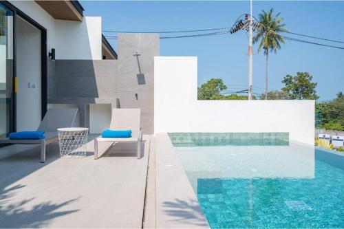 a villa with a swimming pool and a house at Modern Villa Walking Distance to Fisherman Village KBR15 in Amphoe Koksamui