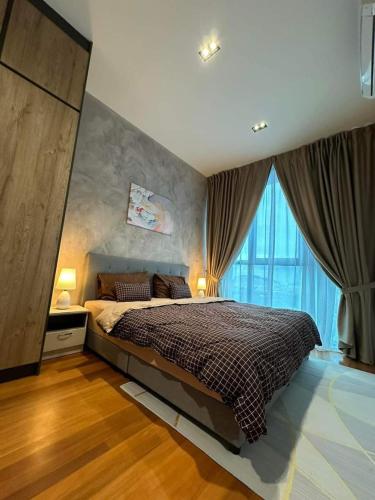 a bedroom with a bed and a large window at coolvibes homes in Cameron Highlands