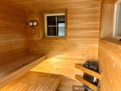 a sauna with a bench and a window at The Gardeners House, Lake View & Sauna in Vreta Kloster