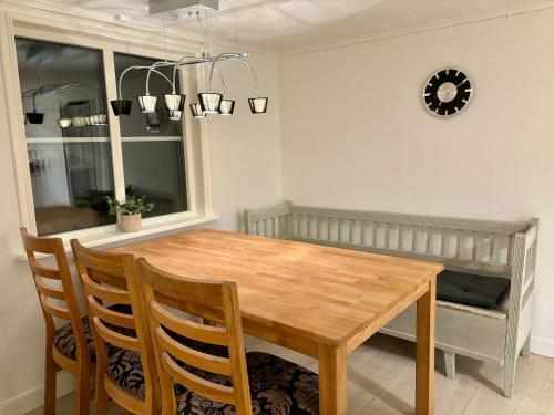 a dining room with a wooden table and chairs at The Gardeners House, Lake View & Sauna in Vreta Kloster