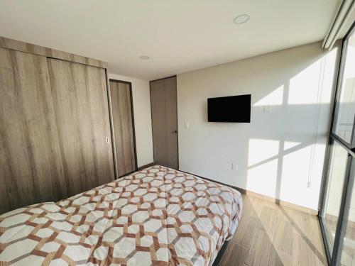 Una cama o camas en una habitación de Departamento nuevo a 5 cuadras de Roma Norte. En Vértiz 253