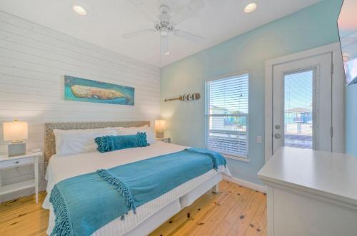a bedroom with a bed and a desk and a window at Best Little Shore House by AvantStay Cart Zone in Port Aransas