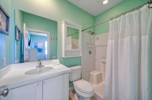 a bathroom with a sink and a toilet and a shower at Best Little Shore House by AvantStay Cart Zone in Port Aransas