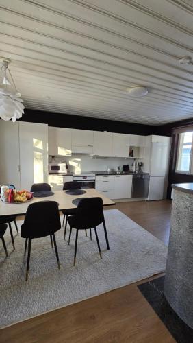 a kitchen with a table and chairs in a room at Pohjankatu (Vanha Rauma) in Rauma