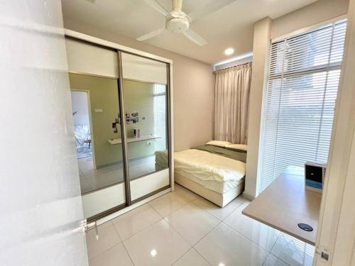 a bedroom with a bed and a large mirror at Mount Austin Retreat in Johor Bahru