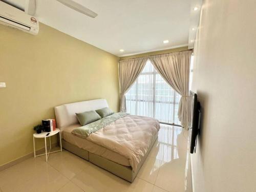 a bedroom with a bed and a large window at Mount Austin Retreat in Johor Bahru