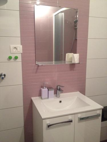a bathroom with a sink and a mirror at Guesthouse Mala Luce Stobreč in Split