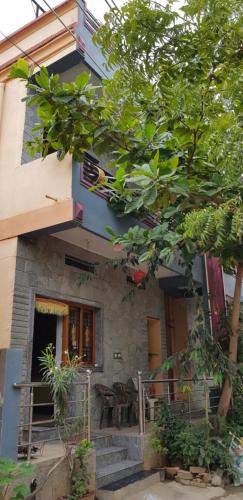 a house with a staircase in front of it at Prakash Homestay in Hampi