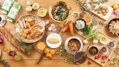 a wooden table with many different types of food on it at Hotel Concorde Hamamatsu in Hamamatsu