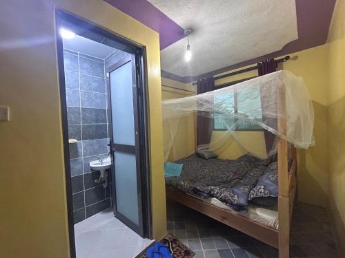 a small room with a bunk bed and a shower at 020-22 Airbnbs in Thika