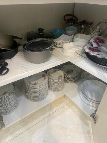 a shelf filled with plates and pans and dishes at Green House in Dilijan