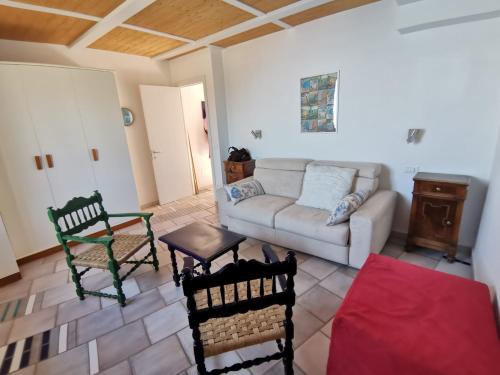 a living room with a couch and a table at Il Nido Del Falco - Art house with terrace and sea view in Furore