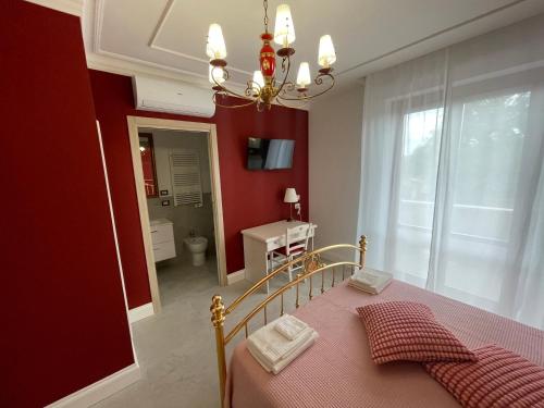 a bedroom with a bed and a red wall at Nonna Mina B&B in Rapagnano