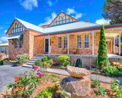a brick house with a garden in front of it at Beauchamp Beauty - Loft apartment in Albany