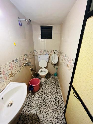 a bathroom with a toilet and a sink at Coral Reef - NestinGoa Homestays in Arambol