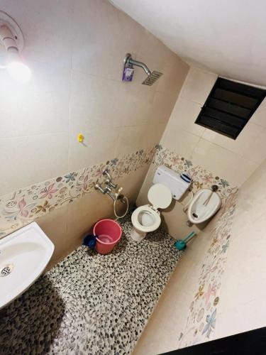 a bathroom with two toilets and a sink at Coral Reef - NestinGoa Homestays in Arambol