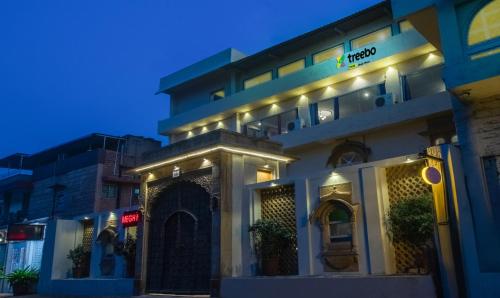 a building with lights on the side of it at Treebo Trend Megh Niwas - Jodhpur in Jodhpur