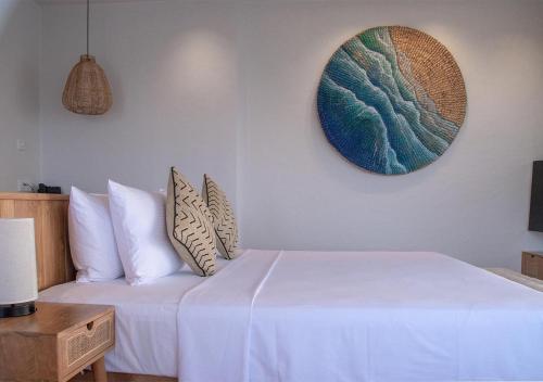 a bedroom with a bed and a table and a mirror at Stone Hotels Dhiffushi in Dhiffushi