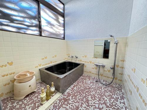 a bathroom with a bath tub and a toilet at Calmbase Nishi Izu - Vacation STAY 30929v in Toda