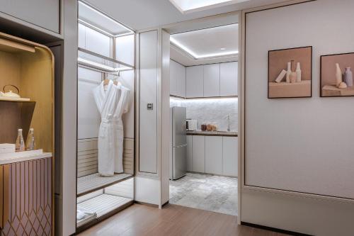 a dressing room with a white dress on a mannequin at MaxX by Steigenberger Guangzhou Zhujiang New Town - Free Shuttle bus to Canton Fair Complex during Canton Fair Period in Guangzhou