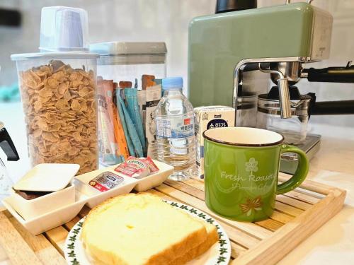 a table with a coffee cup and a piece of bread at Recipe in Mokpo