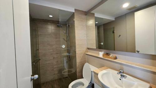 a bathroom with a toilet and a sink and a shower at The Patio BangsaenF6 R71 in Ban Bang Saen (1)