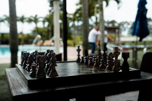 a chess board with chess pieces on a table at Finca Hotel Yerbabuena in Pereira