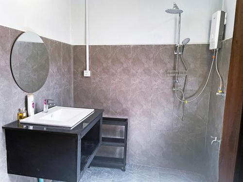 a bathroom with a sink and a shower at Garden Riverside in Kampot