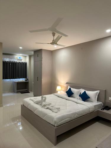 a bedroom with a large bed with a ceiling at Cloud Stay in Guwahati