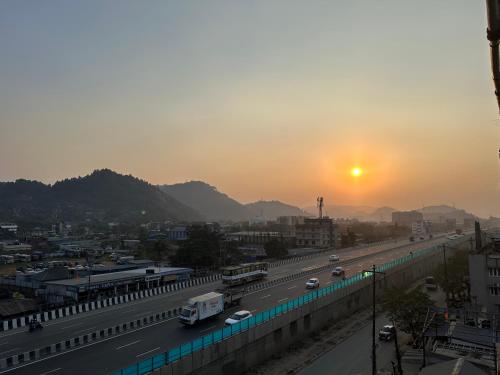 a view of a highway with the sunset in the background at Cloud Stay in Guwahati