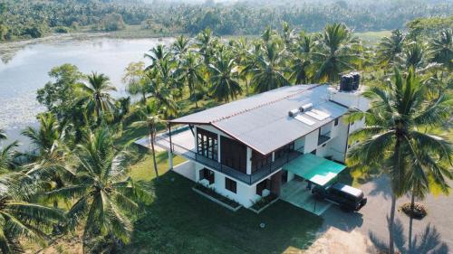 an aerial view of a house with palm trees at Tsuru Villa in Udawalawe