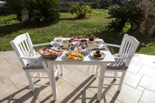 a white table with bowls of food on it at Arodamos Studios & Apts in Kissamos