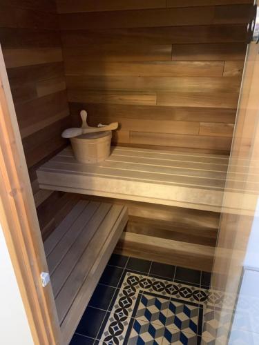 a sauna with a tub and a bucket at Stroma, Dunnet, spacious holiday house with sauna. in Brough