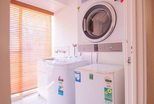 a washer and dryer in a white room with at Family Oasis At Busselton in Geographe