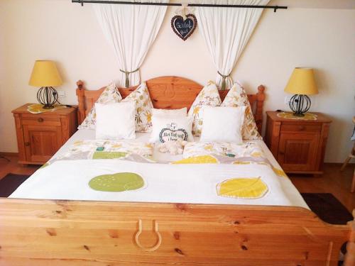 a bedroom with a large bed with two night stands at FerienAppartments Landhaus FühlDichWohl in Fehring