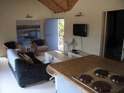 a kitchen and living room with a stove top oven at Fishermansrest in Velddrif