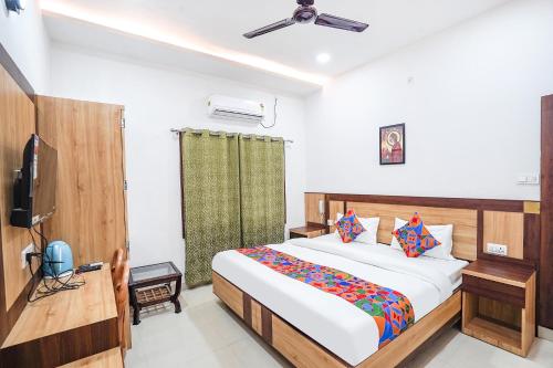 a bedroom with a bed and a television in it at FabHotel Vairagi inn in Varanasi