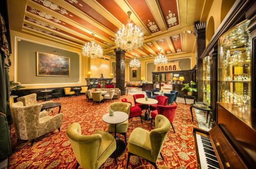 a lobby of a hotel with chairs and tables at Esplanade Hotel Prague in Prague