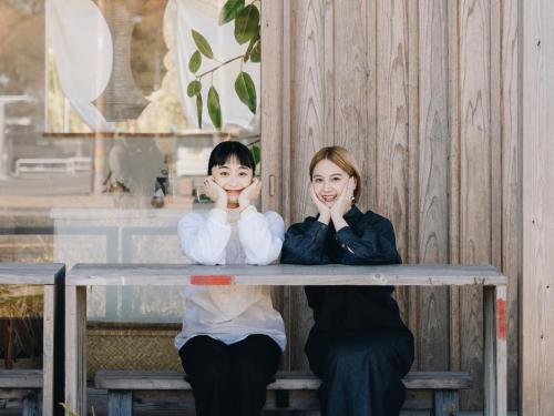 two girls sitting at a table with their hands on their faces at Prince Smart Inn Miyazaki in Miyazaki