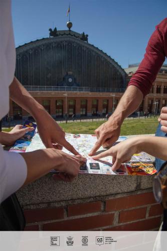 a group of people holding hands over a table at SLEEP'N Atocha - B Corp Certified in Madrid