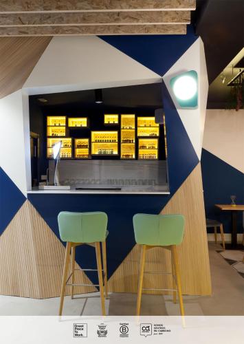 two green chairs in front of a counter at SLEEP'N Atocha - B Corp Certified in Madrid