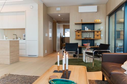 a living room with a couch and a table at Beautiful lodge in Lofoten housing up to 6 guests! in Lyngværet
